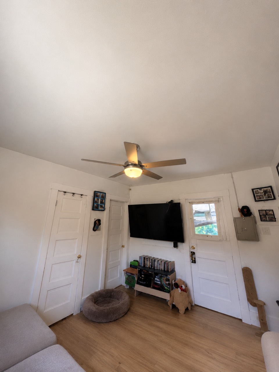 Highland Park living room after ORCCI completed the smooth painted ceiling and new flooring